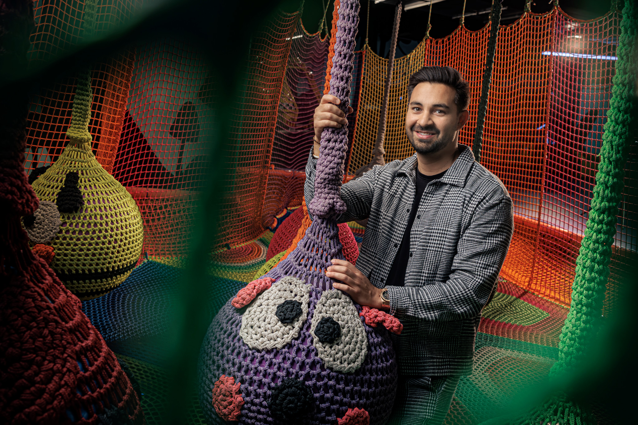 Diego Rohner, nouveau repreneur de Fun Planet, pose dans l’espace kids coloré de Villeneuve, entouré de structures en filet et de personnages en crochet.